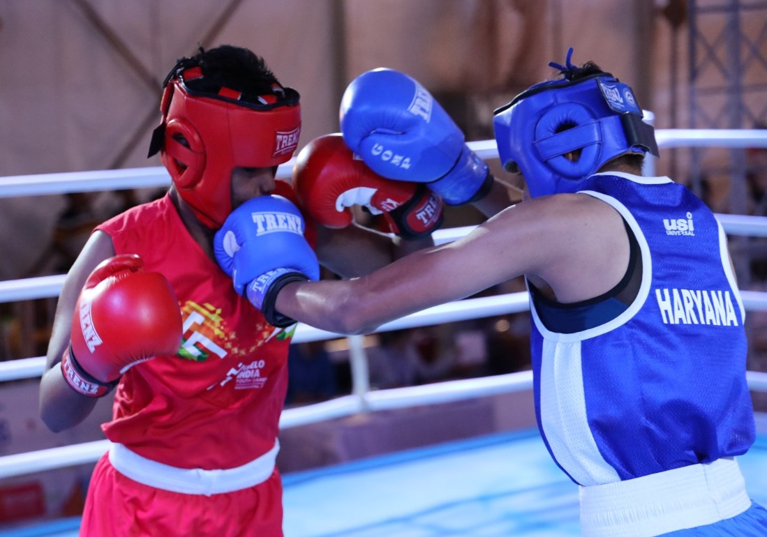 Haryana's Jaismine (in blue) punches her opponent Chattishgarh's Rajbala during 60kg opening round match